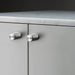 Buster + Punch Furniture Knob Cross in steel finish installed on cabinet doors