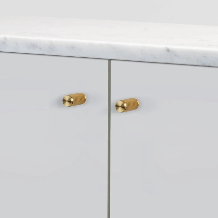 Buster + Punch Linear Brass furniture knobs on modern cabinet doors