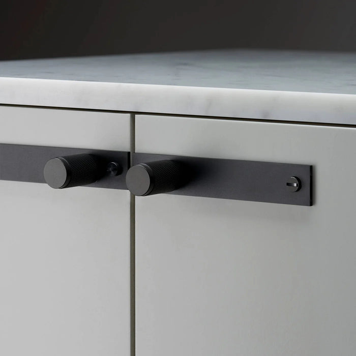 Horizontal installation of Buster + Punch Cross Black furniture knob plate