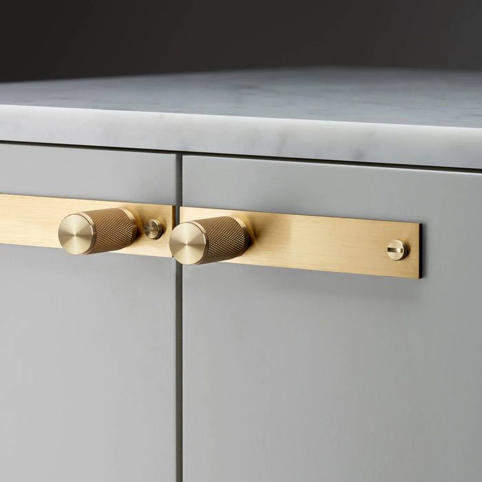 Close-up of Buster + Punch Cross Brass furniture knob plate