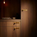 Brass Buster + Punch furniture knob plates in warm luxury interior