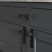 Smoked Bronze Buster + Punch furniture knob plate installed on dark cabinetry