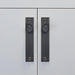 Buster + Punch Furniture Knob Plate Cross in Smoked Bronze finish on white cabinet doors