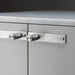 Close-up of Buster + Punch Cross Steel furniture knob plate on cabinetry