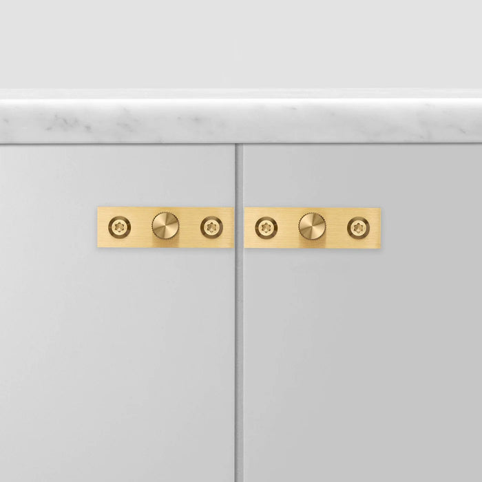Wide cabinet view with Buster + Punch Linear Brass knob plates
