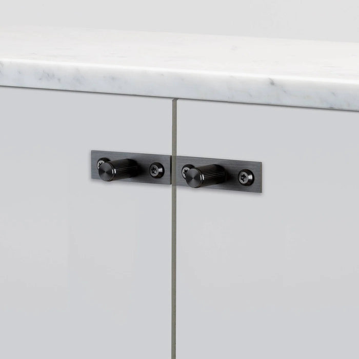 Close-up of Buster + Punch Linear Gun Metal furniture knob plates