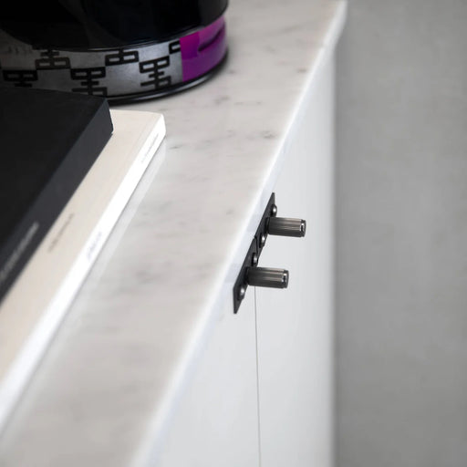 Side angle view of Buster + Punch Linear Gun Metal furniture knob plate