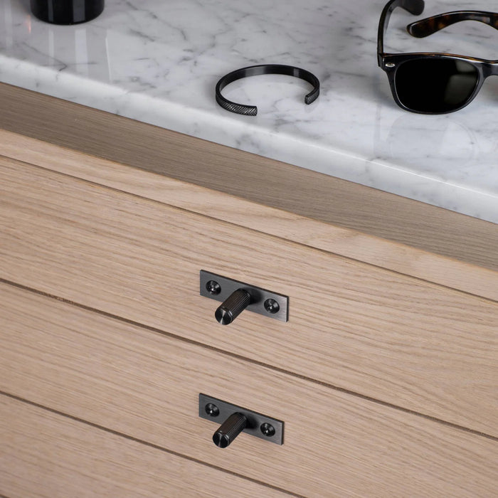 Buster + Punch Linear Gun Metal furniture knob plates installed on wood drawers