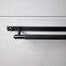 Close-up of black Buster + Punch Linear cabinet pull installed on cabinetry