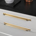 Brass Buster + Punch Linear cabinet pull installed on white drawers