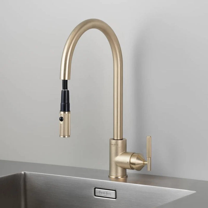 Angled view of Buster + Punch brass kitchen faucet with pull-out spray