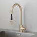 Angled view of Buster + Punch brass kitchen faucet with pull-out spray