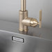 Close-up detail of Buster + Punch brass linear kitchen faucet handle
