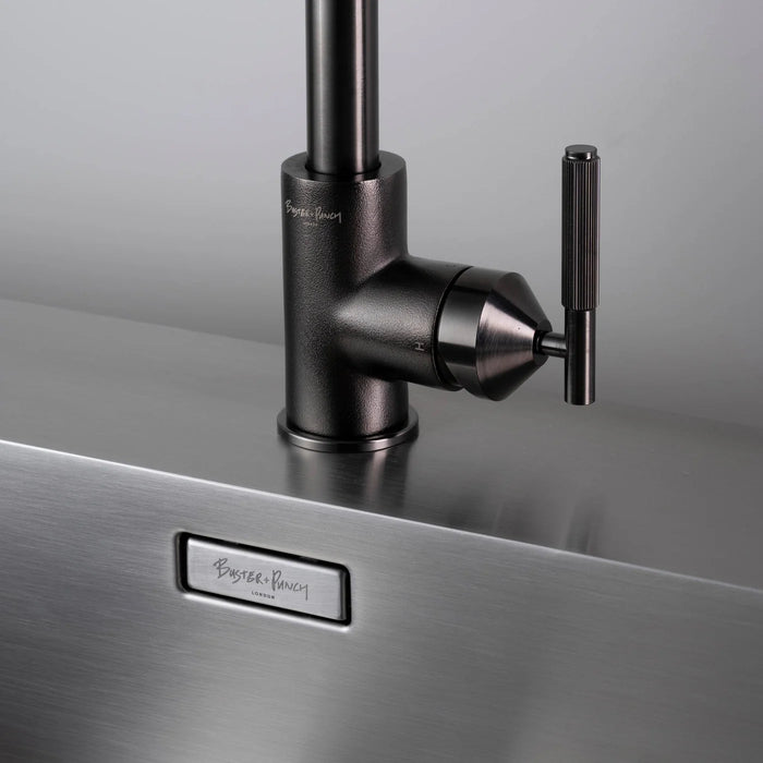 Close-up of Buster + Punch gun metal kitchen faucet handle and base