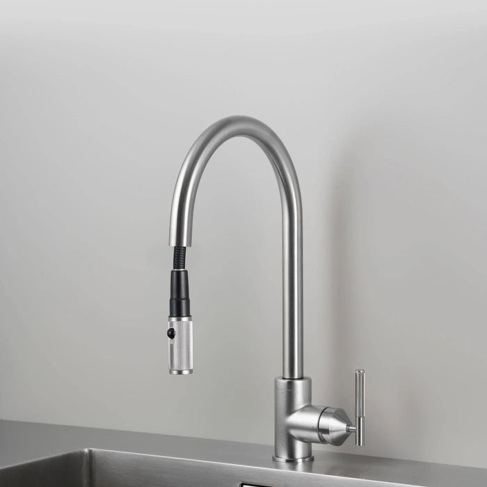 Angled view of Buster + Punch steel kitchen faucet with pull-out spray