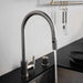 Running water from Buster + Punch linear pull-out kitchen faucet in steel finish