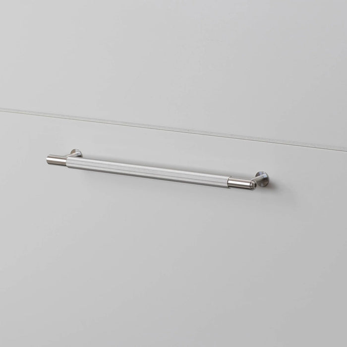 Steel Buster + Punch Linear Pull Bar handles installed on white drawers
