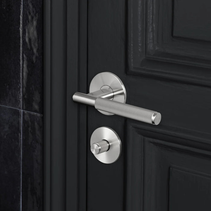 Buster + Punch Linear Thumbturn Lock in Steel finish installed with matching door handle