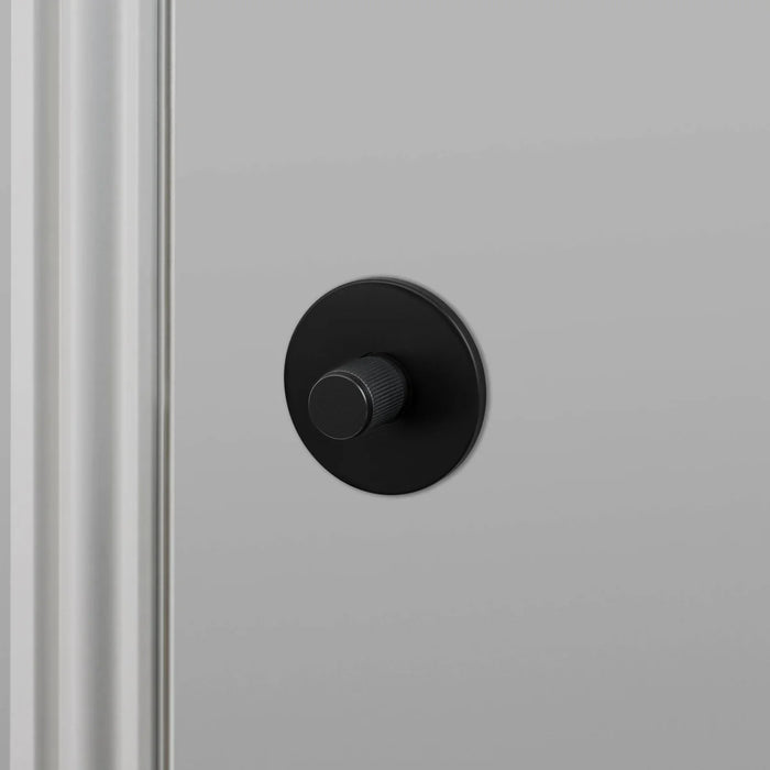 Angled view of Buster + Punch Linear Thumbturn Lock in Welders Black finish