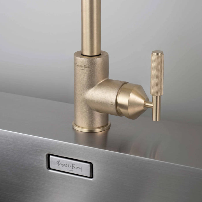 Close-up of Buster + Punch brass faucet with cross-knurled detailing