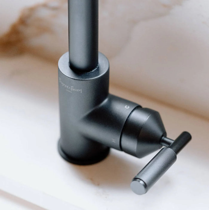 Detailed view of Buster + Punch welder's black kitchen faucet base