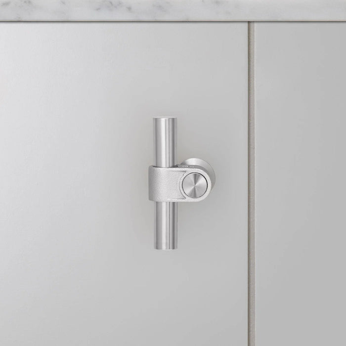 Front view of Buster + Punch T-Bar CAST cabinet knob in steel finish mounted on cabinet door