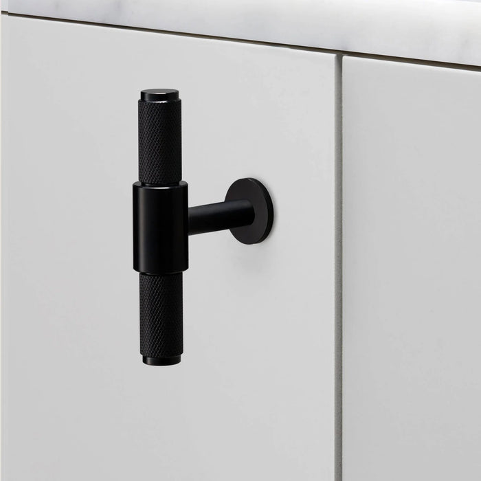 Side view of Buster + Punch T-Bar Cross cabinet knob in Black finish