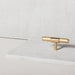 Buster + Punch T-Bar Cross cabinet knob in Brass finish displayed in a modern luxury interior setting