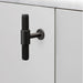 Buster + Punch T-Bar Cross cabinet knob in Smoked Bronze finish mounted on cabinetry