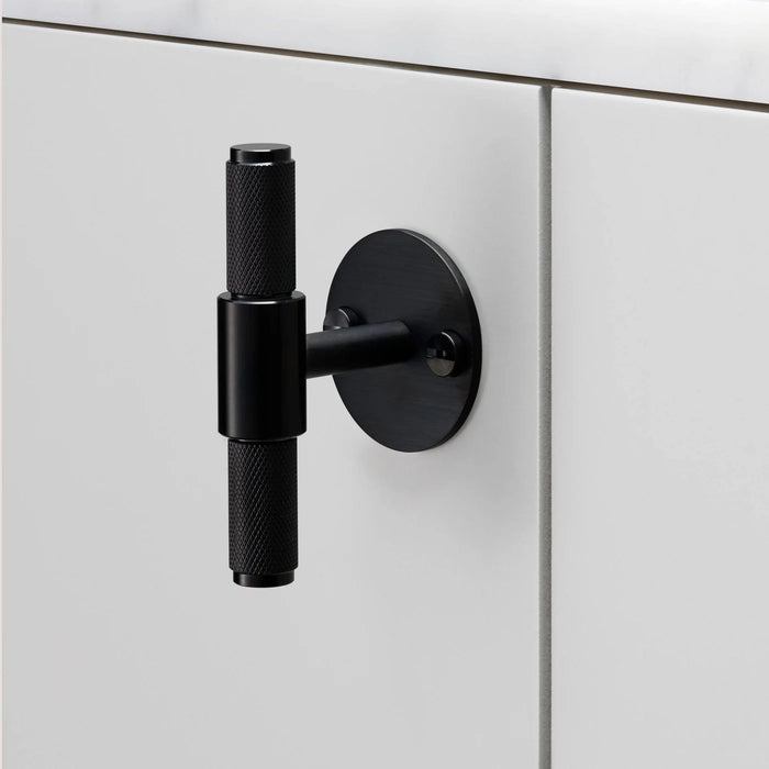 Buster + Punch T-Bar PLATE Cross cabinet knob in black finish mounted on cabinetry