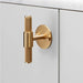 Buster + Punch T-Bar PLATE Cross cabinet knob in brass finish mounted on cabinetry