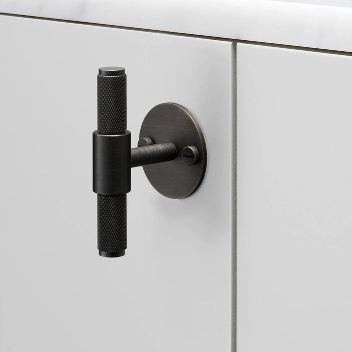 Buster + Punch T-Bar PLATE Cross smoked bronze hardware on white interior display