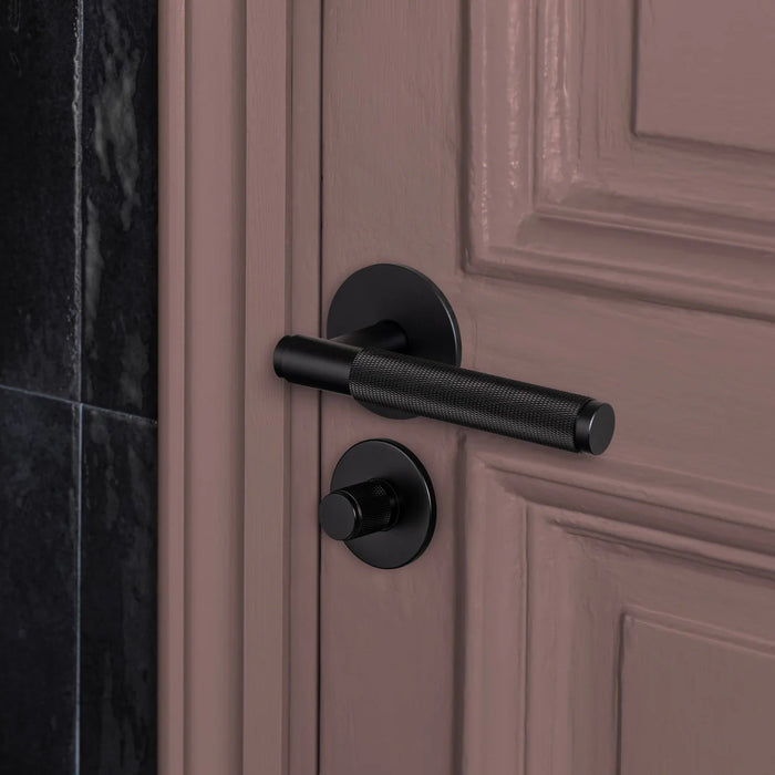 Buster + Punch Cross thumbturn lock in black finish installed on interior door