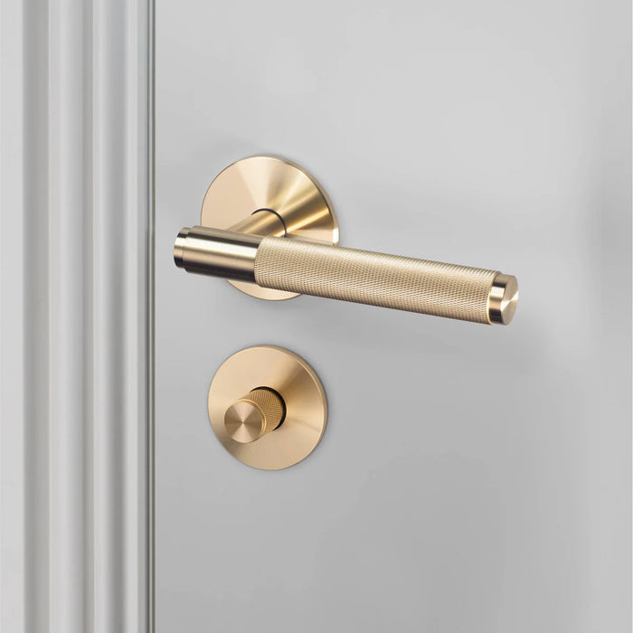 Buster + Punch brass cross thumbturn lock paired with matching door handle