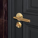 Buster + Punch Cross thumbturn lock in brass finish installed on dark interior door