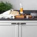 Steel Buster + Punch Cross furniture knob plates on white cabinetry