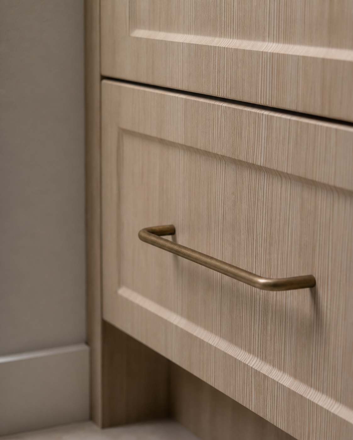 CBH 220 bar pull in antique brass finish installed on light wood cabinet drawer