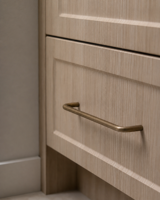 CBH 220 bar pull in antique brass finish installed on light wood cabinet drawer