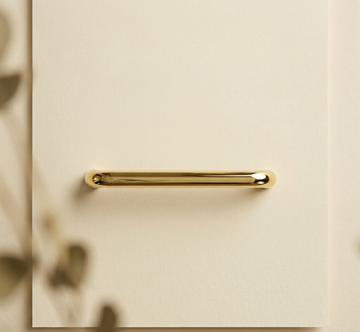CBH 220 bar pull in bright brass finish installed on beige cabinet with soft natural lighting