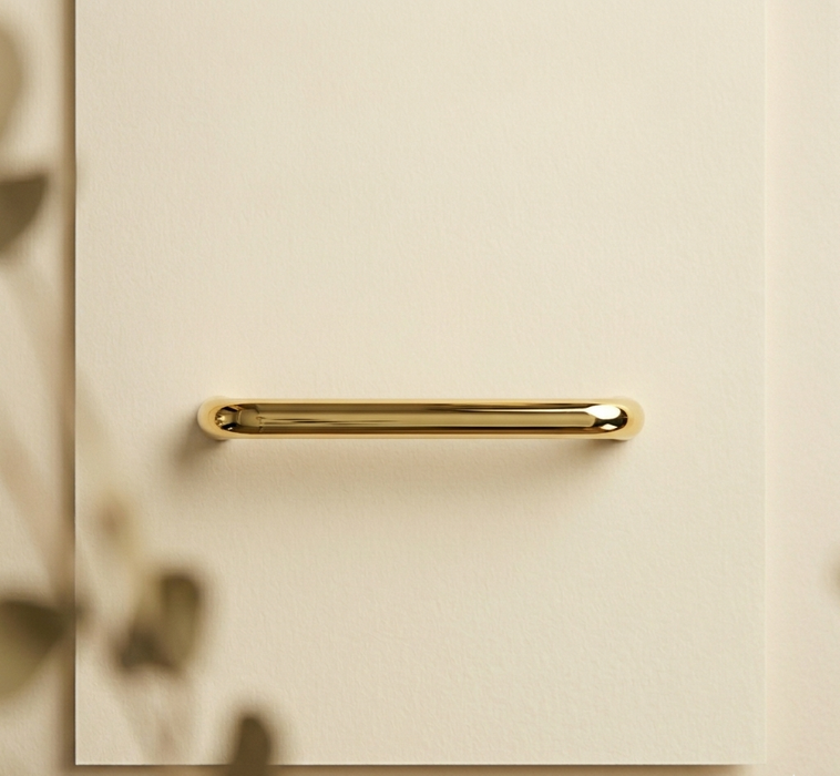 CBH 220 bar pull in bright brass finish installed on beige cabinet with soft natural lighting