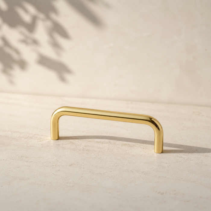 CBH 220 cabinet bar pull in bright brass finish on neutral background minimal product shot