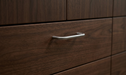 CBH 220 bar pull in bright chrome finish installed on dark wood drawer front