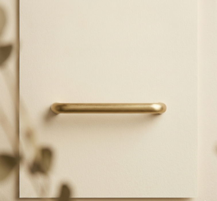 Close-up of CBH 220 bar pull in satin brass finish with soft shadows