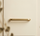 Close-up of CBH 220 bar pull in satin brass finish with soft shadows