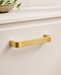 CBH 245 Square Return Bar cabinet pull in satin brass finish installed on cabinet drawer
