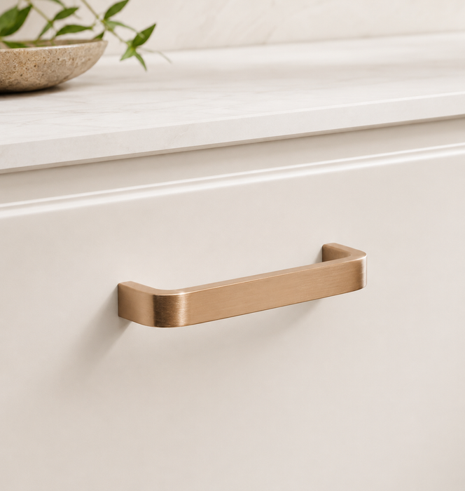 CBH 245 Square Return Bar cabinet pull in satin bronze finish installed on cream cabinetry