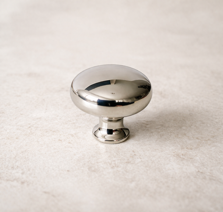 CBH 502 Classic Dome Cabinet Knob in Bright Nickel Plated finish on marble surface