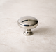 CBH 502 Classic Dome Cabinet Knob in Bright Nickel Plated finish on marble surface