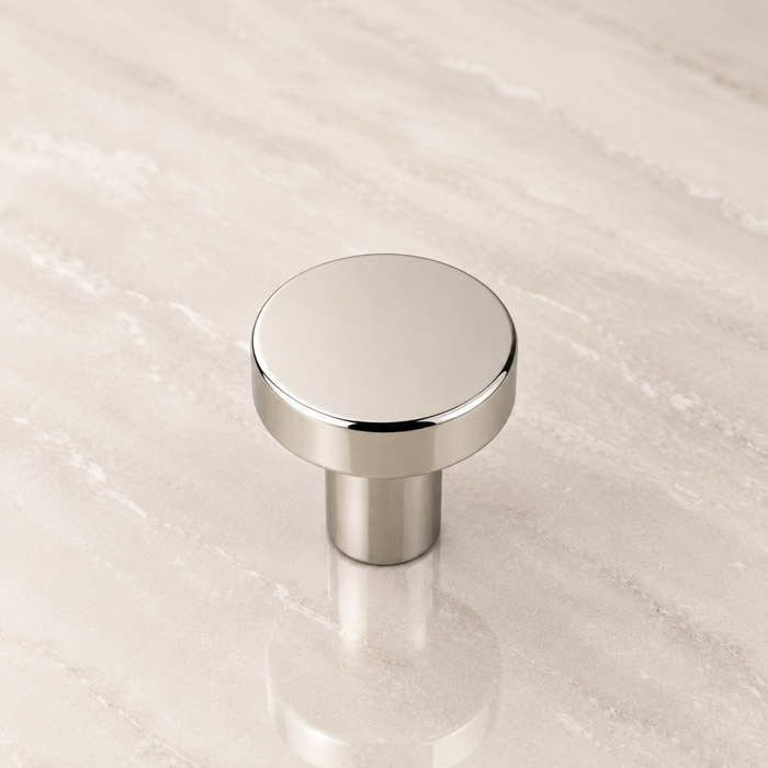 CBH 503 Minimalist Round Cabinet Knob in Bright Nickel Plated finish displayed on marble