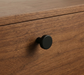 CBH 503 Minimalist Round Cabinet Knob in Flat Black finish installed on wood cabinetry
